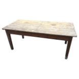 A rectangular Victorian pine kitchen table with plank top on dowel jointed frieze, raised on