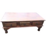 A hardwood coffee table, the rectangular top above three frieze drawers mounted with ring handles,