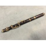 A late nineteenth century piccolo, the wood instrument by H Journet of Tottenham Court Road with