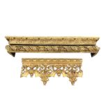 Two resin moulded gilded pelmets with carved leaf style decoration; and a section of faux wood