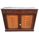 A mahogany side cabinet, the rectangular moulded top above a long frieze drawer with carved