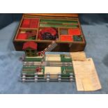 A boxed set of Meccano, the fitted stained case with two trays including wheels, cogs, panels,