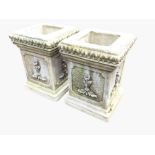 A pair of square composition stone garden pots or stands, with leaf rims above panels cast with