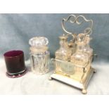 A silver plated glass four-piece cruet stand - HP Special with scrolled central handle, raised on