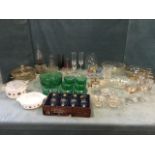 Miscellaneous glass including an oil lamp, bowls, a green glass dessert set, a cranberry bell,