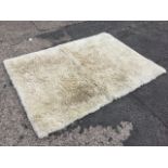 A modern rectangular thick pile husky fireside rug in a polar bear colour. (66in x 48in)