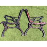 A pair of painted cast iron bench ends, the channelled frames with scrolled arms and bases - need