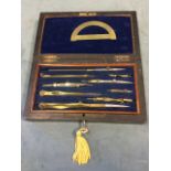 A rosewood cased set of brass drawing instrument, the lined box with fitted internal tray. (8.25in)