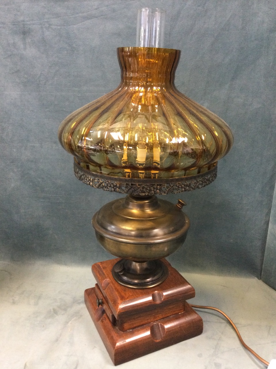 A Victorian brass oil lamp with embossed reservoir on fluted base mounted on glazed stand, fitted - Image 3 of 3