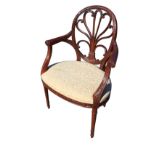 A reproduction mahogany eighteenth century style elbow chair, the oval back with anthemion scrolling