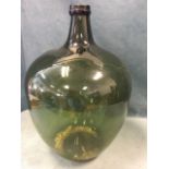A large olive green glass carboy jar with moulded rim. (26in)
