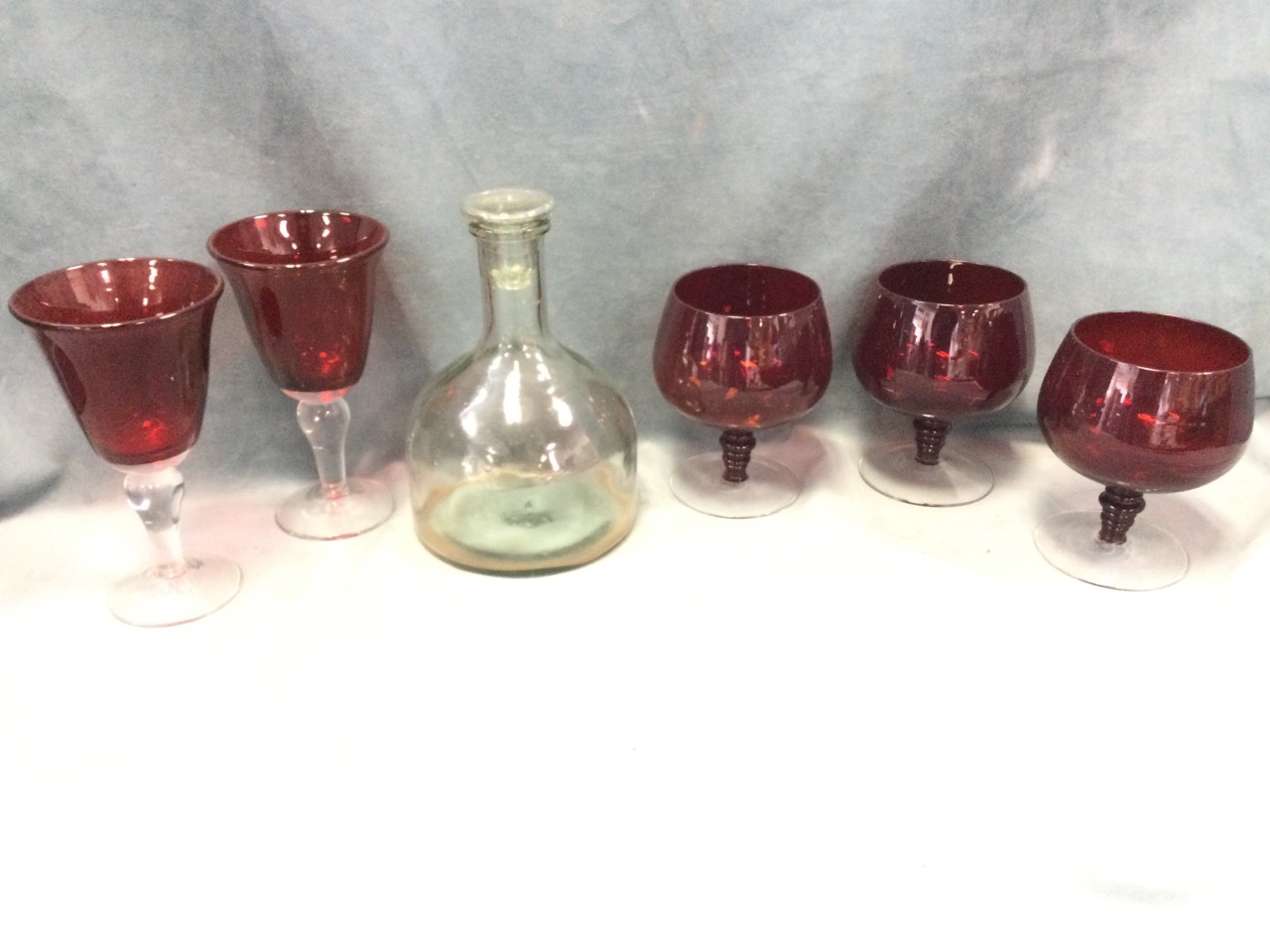 Five large ruby glass vases with clear bases; and a ships style decanter & stopper. (6)