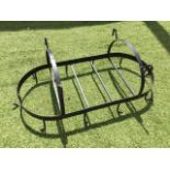 An oval wrought iron kitchen hanging rack, the frame with rods and hooks, below arched hanger