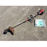 A Mitox petrol driven garden strimmer - with instruction manual, spare pieces, etc. (A lot)