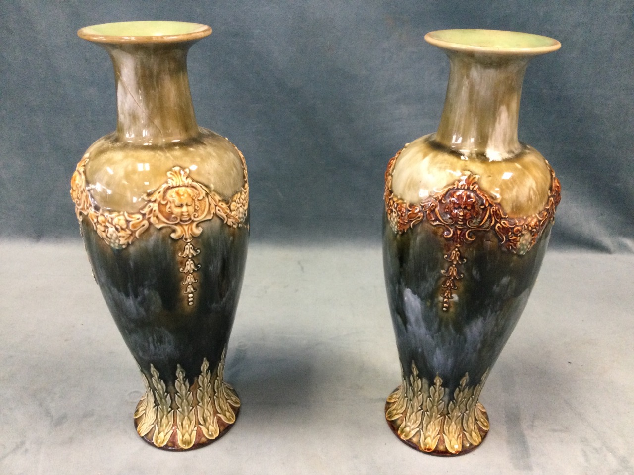 A pair of Royal Doulton tapering stoneware vases with waisted necks, having applied swagged