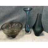 A tapering Swedish blue glass bottle vase with fins; a smoked glass bowl raised on four lobbed feet;