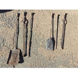 A set of nineteenth century japanned steel fire irons with brass handles - poker, tongs & shovel;