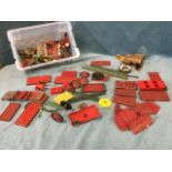 A collection of meccano including a boxed clockwork motor, wheels, panels, a tin of nuts & bolts, an