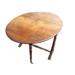 A Victorian walnut sutherland table with two rounded drop leaves forming an oval moulded top,