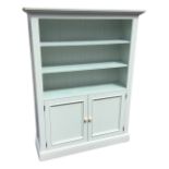 A painted dresser with moulded cornice above three open shelves having tongue & grooved back, the