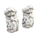 A pair of composition stone Zeus garden seats, the bearded heads with angled rests. (29.5in) (2)