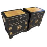 A pair of oriental lacquered cabinets with panelled tops above drawers and cupboards mounted with