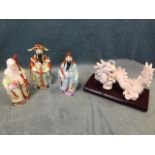 Three Chinese porcelain deities with polychrome kimono decoration; and an eastern porcelain blanc-