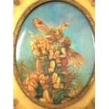 A glazed oval porcelain panel of fairies, in foliate moulded gilt & gesso frame, the verso incised