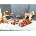 Three tinplate model vehicles - a fire engine, a racing car and a steam traction engine; a four