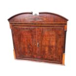 The top of a regency mahogany cabinet, the arched crest with boxwood & ebony stringing and satinwood