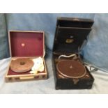 A cased Philips 1950s portable record player; and a cased wind-up gramophone with diaphragm arm