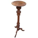 A Victorian mahogany jardiniere stand with circular moulded top supported on a fluted turned &