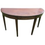 A D-shaped mahogany hall table, the top above a plain frieze with boxwood and ebony stringing,