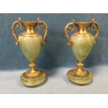 A pair of ormolu bronze cassolettes with tapering onyx urns mounted with acanthus cast handles,