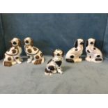 A pair of Victorian Staffordshire wally dogs with copper lustre decoration, the front legs