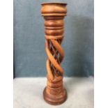 A carved hardwood torchere candlestand with bowl on twisted pierced column, above a circular moulded