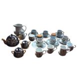 A collection of Buchan stoneware handpainted with flowers on pale blue ground, including jugs,