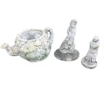 A composition stone mermaid; a giant teapot garden ornament moulded with ivy leaves; and a