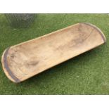 A European hardwood dough trough, adzed out of the solid, having iron mounts to curved ends. (39in)