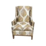 A contemporary armchair by Fairfield in leaf printed upholstery having angled padded back and