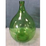 A large green glass carboy, the indented ribbed base with makers mark, the tapering vessel with twin