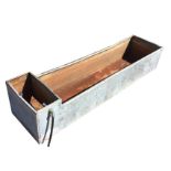 A rectangular 6ft galvanised trough with tubular rim, having compartment for water supply to end. (