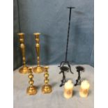 A pair of Victorian brass candlesticks on rectangular canted bases; a pair of octagonal brass