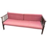 A C20th stained sofa forming a bed, with later loose cushions and sprung base, the back & sides