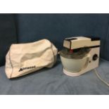 A Kenwood electric mixer with various bowls/attachments, complete with original vinyl cover.
