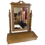 A Victorian style pine dressing table mirror, the rectangular plate with shaped crest supported on