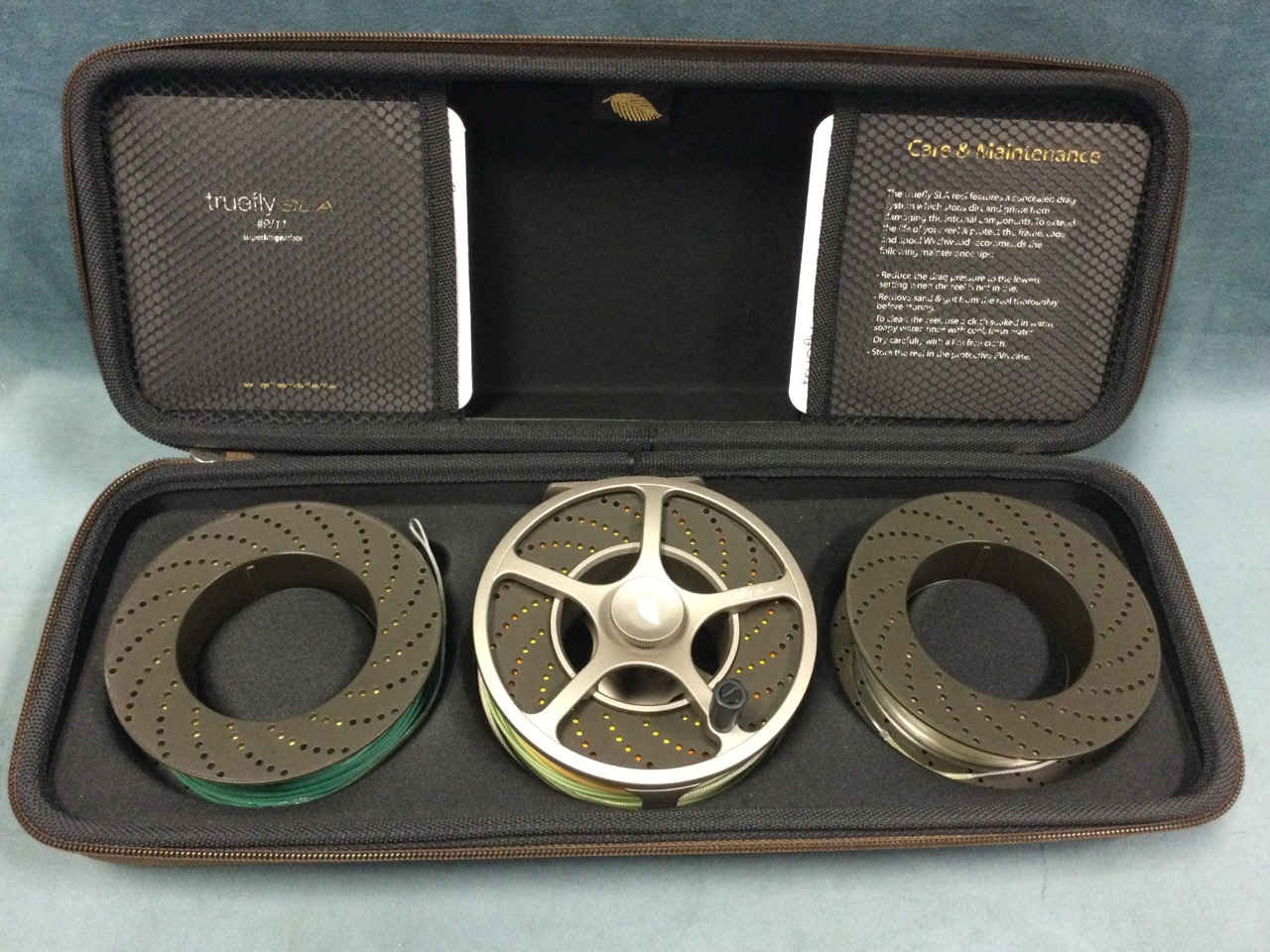 A cased Wychwood 4.5in salmon fly reel with two spare interchangeable spools, the case with original