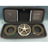 A cased Wychwood 4.5in salmon fly reel with two spare interchangeable spools, the case with original