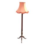 An Edwardian mahogany standard lamp with tapering fluted column on tripartite base with pointed