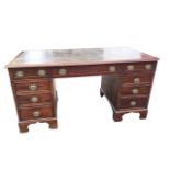 A nineteenth century mahogany kneehole desk, with gilt tooled leather skiver to rectangular
